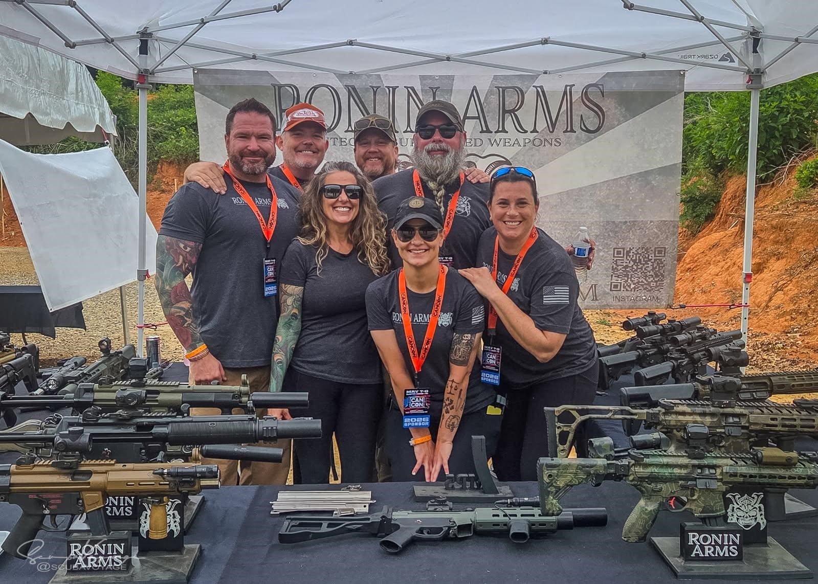 Ronin Arms team at a cancon event booth with firearms on display
